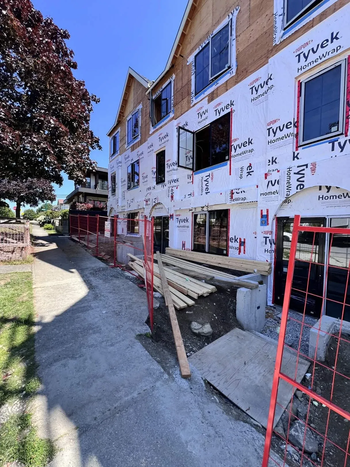 Tyvek HomeWrap installation with red safety fencing