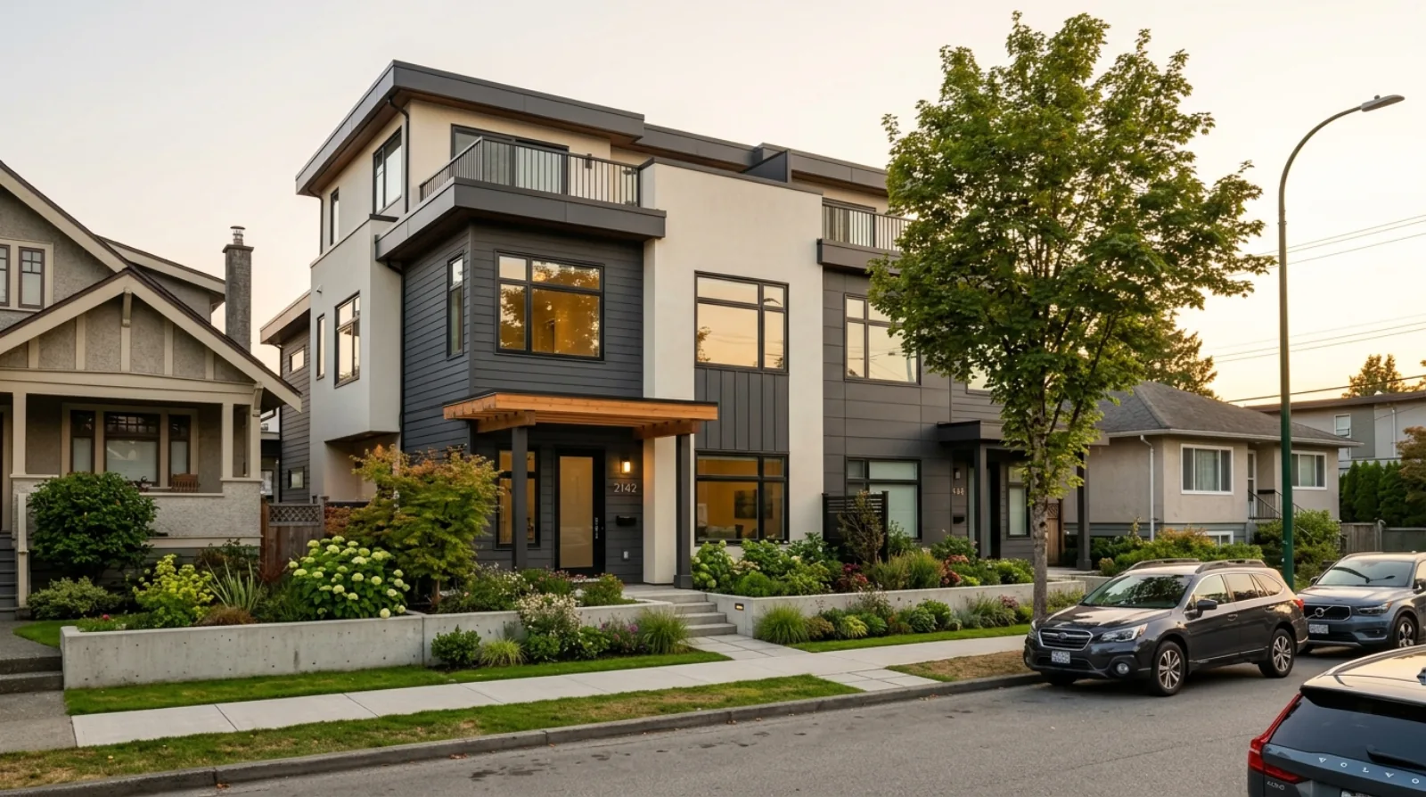A completed prefab triplex multiplex at golden hour on a Vancouver residential street